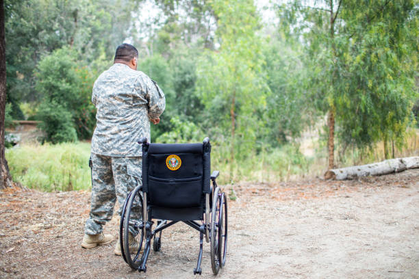 istock Veteran Standing next to Wheelchair 1158078481