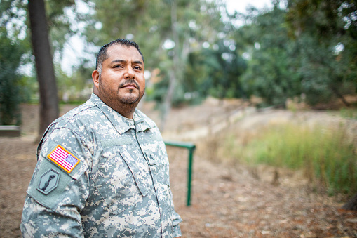 A hispanic veteran wearing his uniform