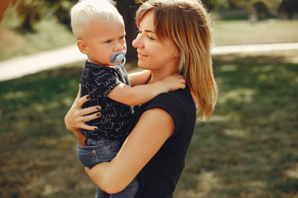 istock Mother with son playing in a summer park 1158079266