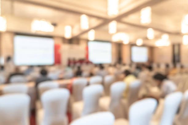 Seminar or town hall meeting blur background in hotel conference room with audiences and speaker podium stage with presentation screen for entrepreneurship business speech or community talk discussion Seminar or town hall meeting blur background in hotel conference room with audiences and speaker podium stage with presentation screen for entrepreneurship business speech or community talk discussion summit meeting photos stock pictures, royalty-free photos & images