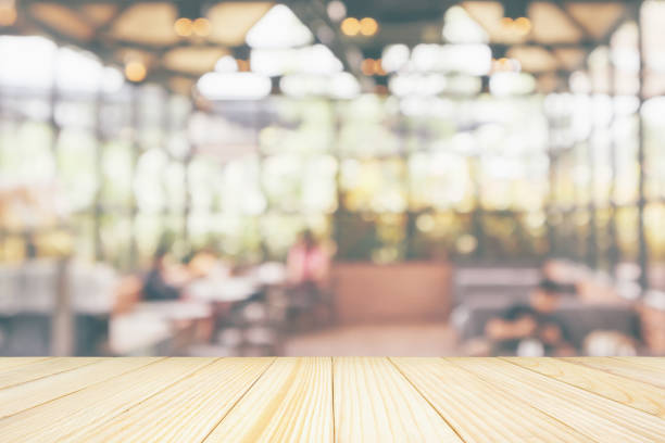 istock Empty wooden table top with cafe restaurant coffee shop interior abstract blur defocused with bokeh light background for montage product display 1158086014