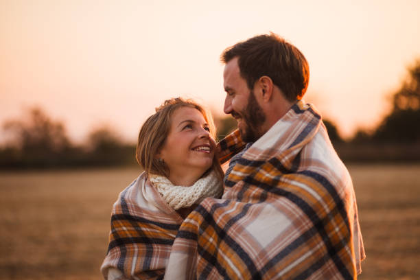 istock Couple wrapped in a blanket outdoors 1158086106