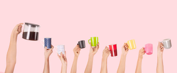 istock Many different arms raised up holding coffee cup 1158087451