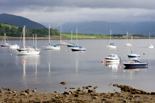 Picture taken of boats moored off Port Bannatyne. This port is located on the Western Isle of Bute off mainland Scotland in the UK. It had been rainy heavily and another downpour was on the way. There are no identification markings on any of the vessels.