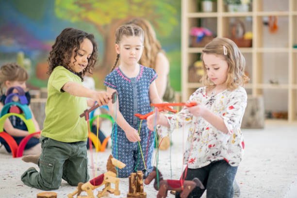 istock Waldorf elementary school children playing with wooden puppets in class 1158090036