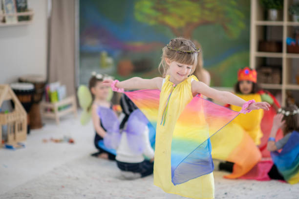 waldorf elementary kids trying on costumes and dancing - preschooler plant preschool classroom imagens e fotografias de stock