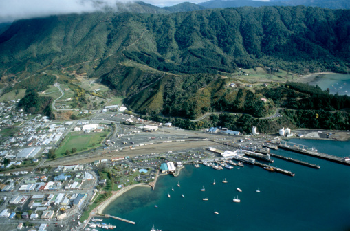 Aerial view at the harbour of Picton (South Island New Zealand), a bay with a group of ships and a part of Picton in front of the beautiful scenery of the Marlborough Sounds are to be seen.