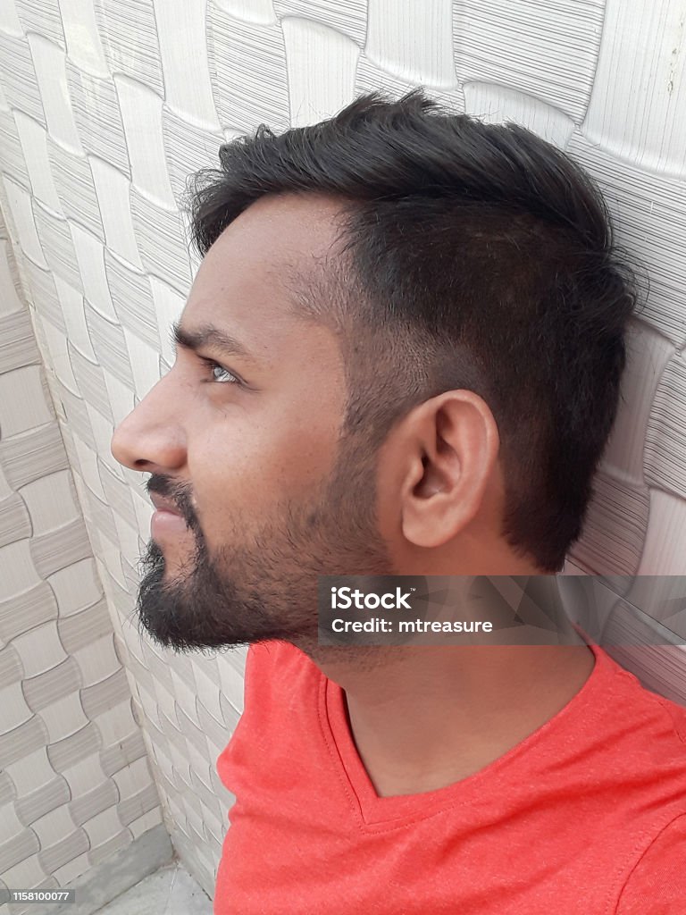 Image Of Young Happy Smiling Handsome Indian Man In Early 20s Wearing Red Vneck Tshirt Taking Self Portrait Selfie Photo On Mobile Phone Camera Standing By Textured Wallpaper With Checks Trendy Hairstyle Image Of Young Happy Smiling Handsome Indian Man In Early 20s Wearing Red Vneck Tshirt Taking Self Portrait Selfie Photo On Mobile Phone Camera Standing By Textured Wallpaper With Checks Trendy Hairstyle