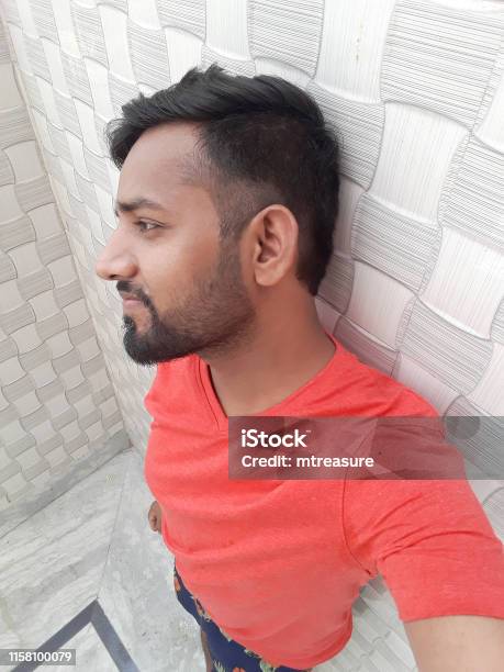 Image Of Young Happy Smiling Handsome Indian Man In Early 20s Wearing Red Vneck Tshirt Taking Image Of Young Happy Smiling Handsome Indian Man In Early 20s Wearing Red Vneck Tshirt Taking