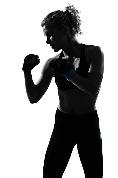 woman workout boxing posture one woman boxing combative sport posture  in studio   on white background fighting stance stock pictures, royalty-free photos & images