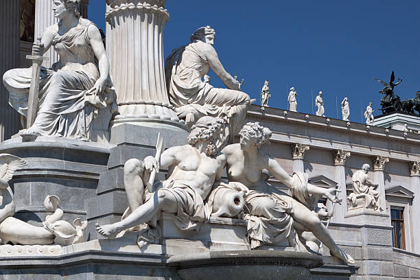 Austrian parliament building with famous Pallas Athena fountain. The statue Pallas Athena, greek goddess of wisdom. stock photo