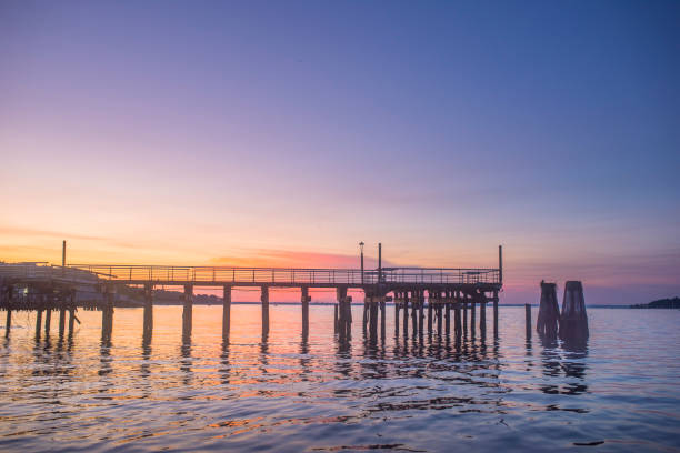 istock Sunset over an empty fishing pier and boat basin. 1158102645