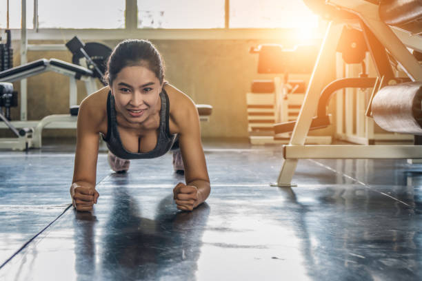 istock female exercising with push up in gym 1158106842