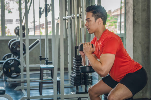 istock male lifting dumsbells in gym 1158106845
