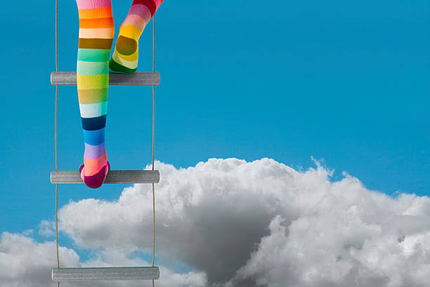 Adventure, escapism, dreams or aspirations... rainbow stocking legs climb above the clouds. Portrait version available.