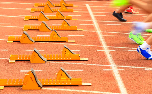 istock sprint start in track and field in blurred motion 1158109152