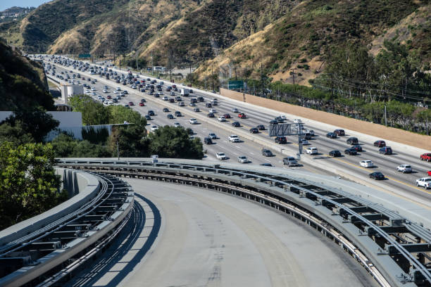 istock Road Going Downhill Near Traffic Jammed Freeway 1158110788