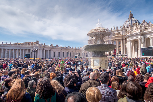 Vatican City, Italy - March 25, 2018: a crowd of catholics at a mass with the Pope in front of the Basilica Saint Peter