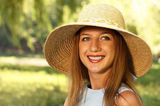 istock Smiling woman in straw hat 115811308