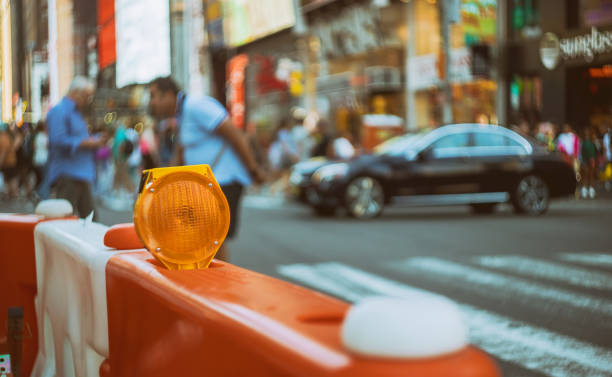 istock Construction zone orange traffic barrier barrels to detour traffic around shallow depth 1158114407