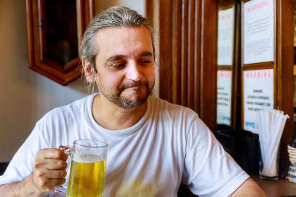 istock Man drinking beer of handsome man drinking beer while sitting 1158114501