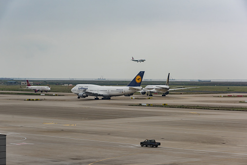 Shanghai, China - May 14, 2019: holding apron of Shanghai Pudong International Airport, airplanes of various airlines are waiting to take off.
