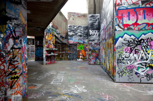 Road tunnel, with graffiti, under a railway line in Bethnal Green east London. March 2023