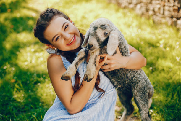 istock beautiful girl with goat 1158116767