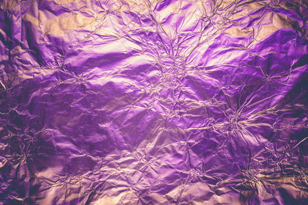 istock Violet deformed background made of illuminated foil. Trendy duotone texture 1158117447
