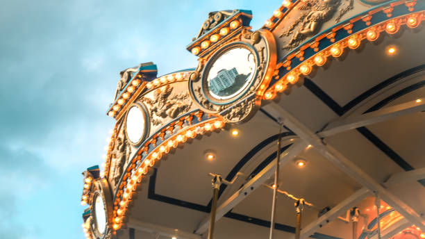 istock Merry-Go-Round (carousel) illuminated at night.reflection cityscape 1158118574