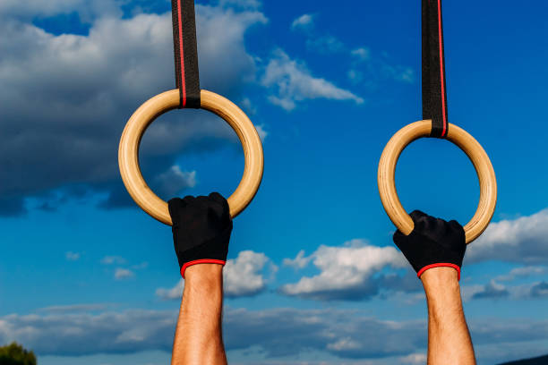 An anonymous athlete doing cross training with rings in the gym.