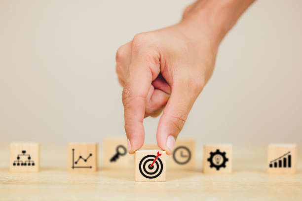 istock hands of busines hold a target with arrow,stacking wooden blocks into steps,Concept of business growth success 1158123904
