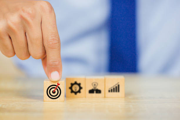 istock hands of busines hold a target with arrow,stacking wooden blocks into steps,Concept of business growth success 1158124536
