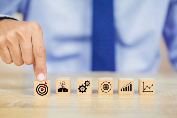 istock hands of busines hold a target with arrow,stacking wooden blocks into steps,Concept of business growth success 1158124541