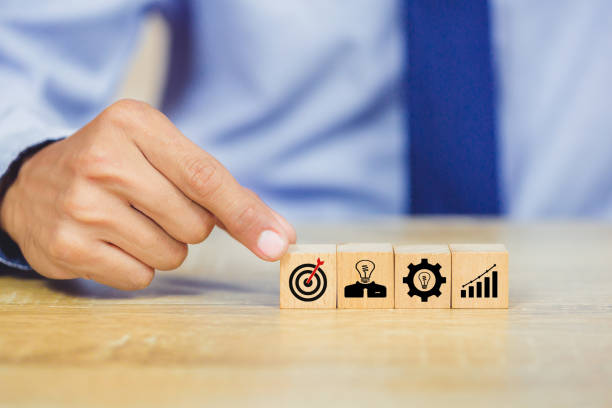 istock hands of busines hold a target with arrow,stacking wooden blocks into steps,Concept of business growth success 1158124547