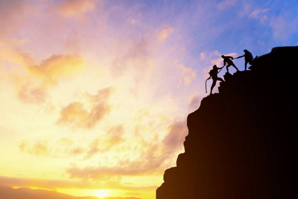 istock Asia couple hiking help each other silhouette 1158125548