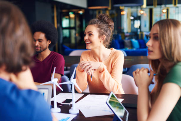 istock Young coworkers talking at conference table 1158126630