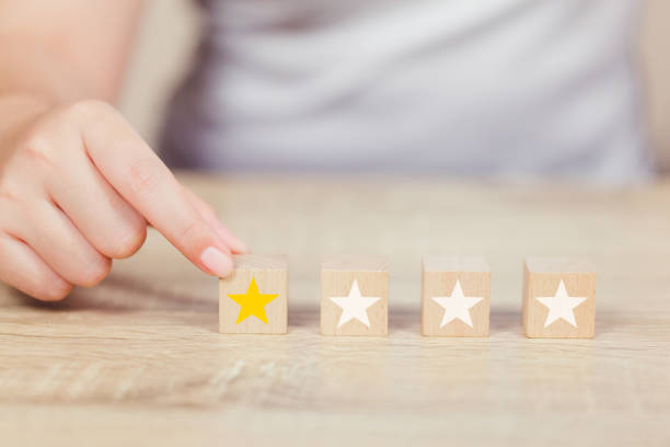 istock customer pressing star on wood cube, Service rating, satisfaction concept. 1158126758