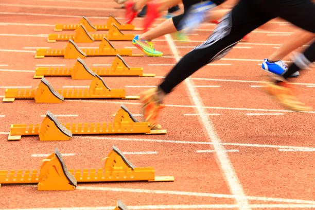 istock sprint start in track and field in blurred motion 1158126784