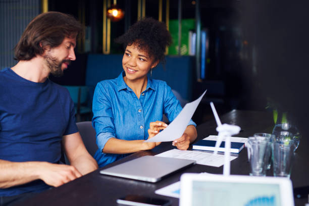 istock Young adult coworkers analyzing the documents 1158126984