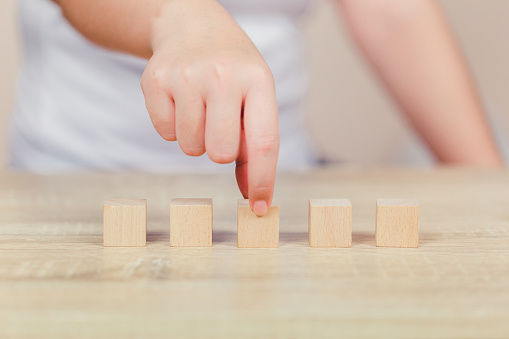 Closer up hands of businessmen,stacking wooden blocks into steps,Concept of business growth success