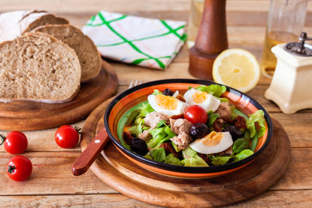 istock Nicoise salad at plate with bread lemon salt and pepper mill 1158130572