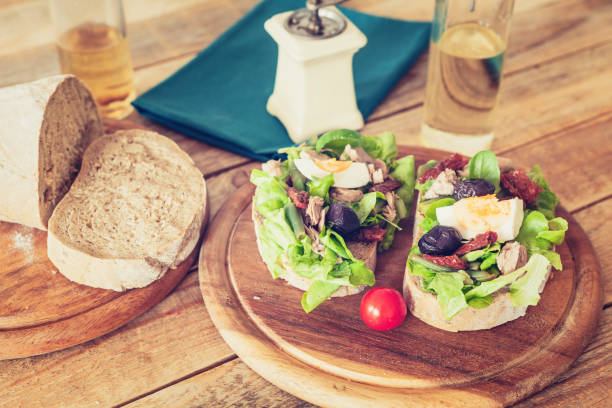 istock Nicoise salad at dark bread slices at plate 1158130680
