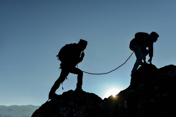 istock concept of professional two climbers crossing the cliffs 1158130704