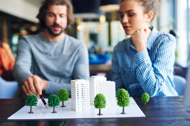 istock Architectural model and young adults architects in the background 1158131779