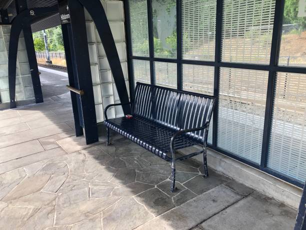 istock Empty isolated black colored  iron bench lying one a object at the train station 1158132075
