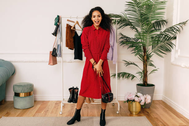 istock Happy buyer in red dress posing in studio 1158134677