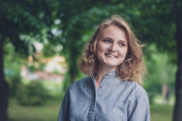 istock young girl in the park sincerely smiling 1158136572