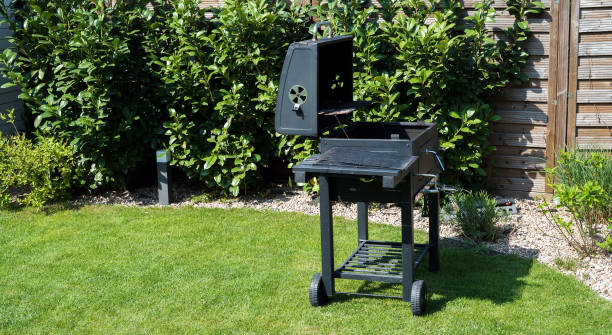 Grill with prepared charcoal for grilling outdoors on backyard stock photo