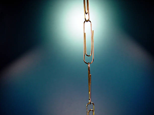 chain of paperclips with blue backlighting